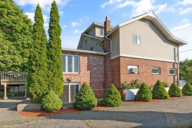 view of home's exterior with a wooden deck