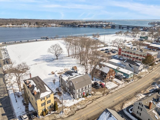 snowy aerial view with a water view