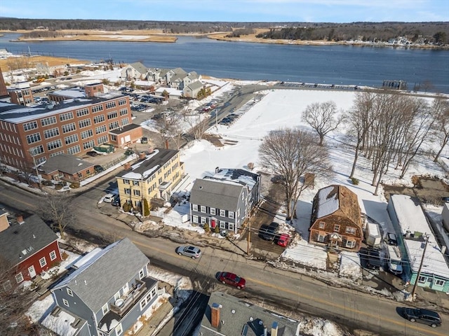 snowy aerial view with a water view