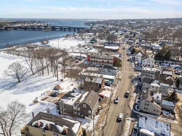 snowy aerial view featuring a water view