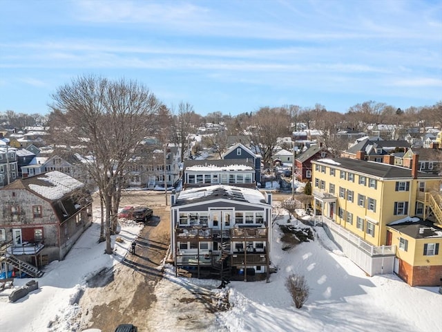 snowy aerial view featuring a residential view