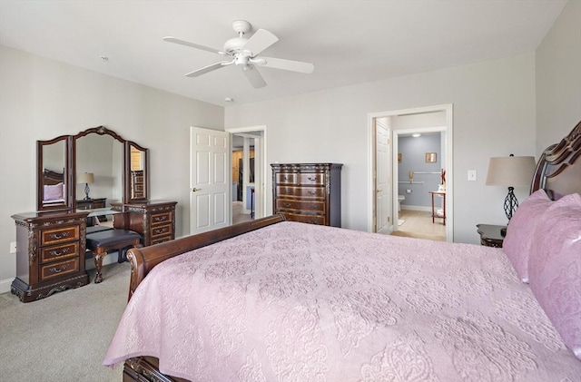 bedroom with ceiling fan, ensuite bathroom, and light carpet