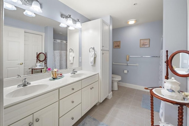 bathroom featuring tile patterned floors, vanity, and toilet