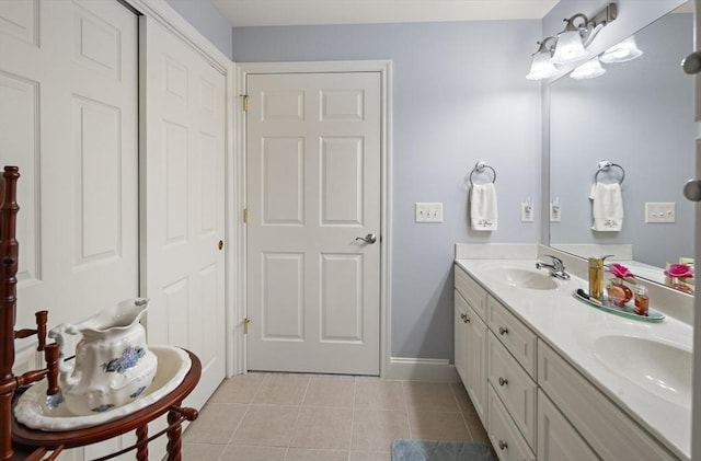 bathroom featuring tile patterned flooring and vanity