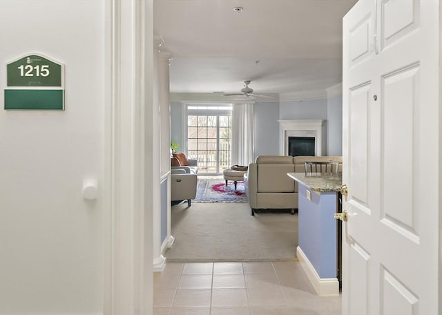 hallway featuring crown molding and light colored carpet