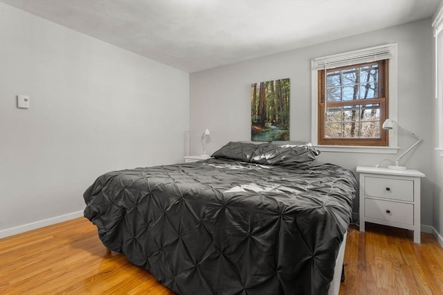 bedroom featuring light wood-type flooring and baseboards