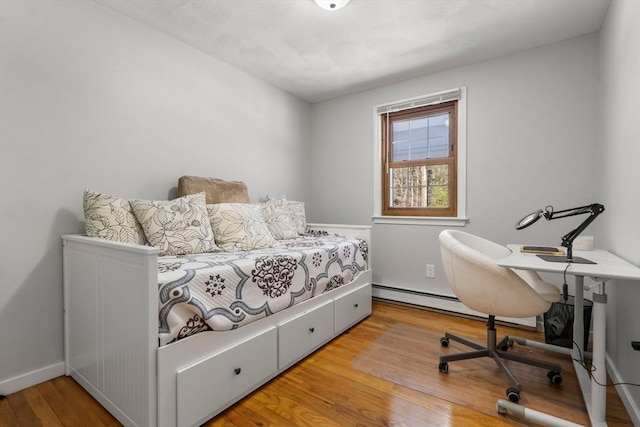 bedroom with wood finished floors and baseboards