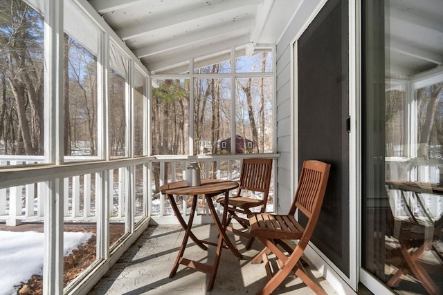 sunroom / solarium featuring lofted ceiling