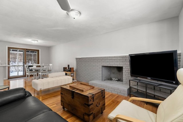 living area with a fireplace and light wood finished floors