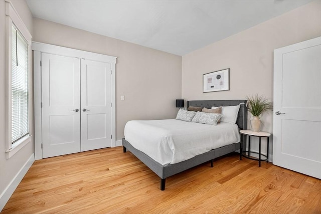 bedroom with a closet and light hardwood / wood-style floors