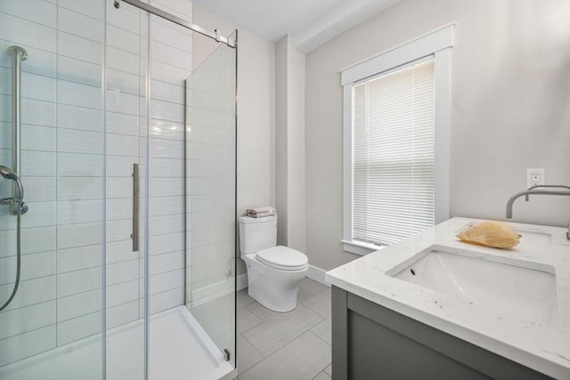 bathroom with tile patterned floors, toilet, vanity, and walk in shower