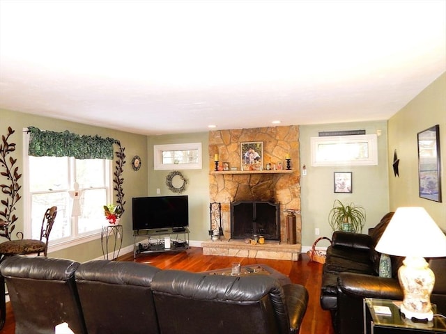 living room featuring hardwood / wood-style flooring and a fireplace