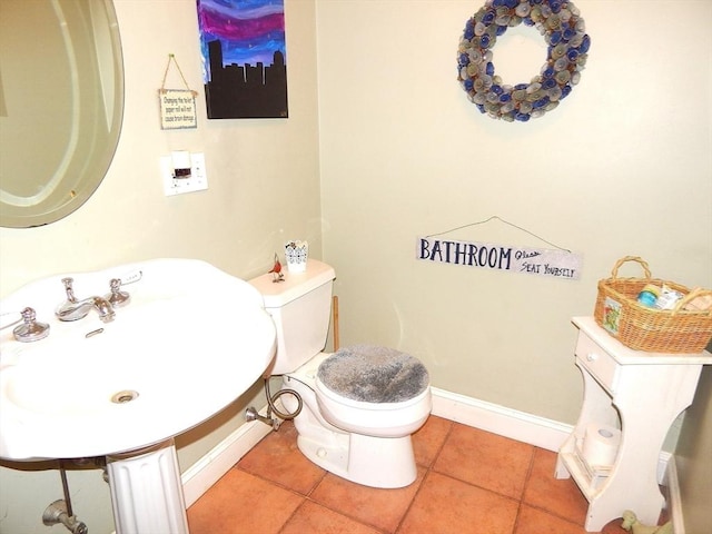 bathroom featuring sink, tile patterned floors, and toilet