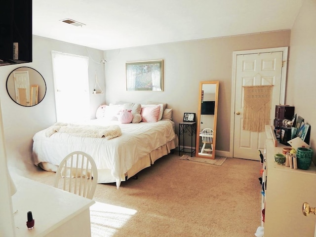 bedroom with light colored carpet