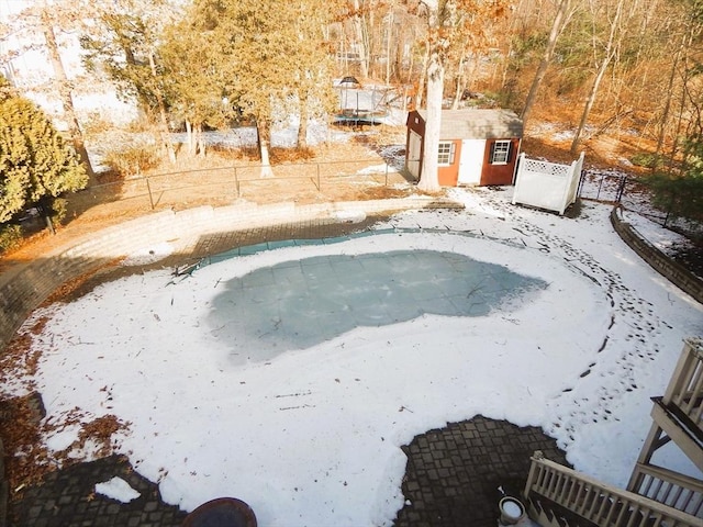 snow covered pool with a storage unit