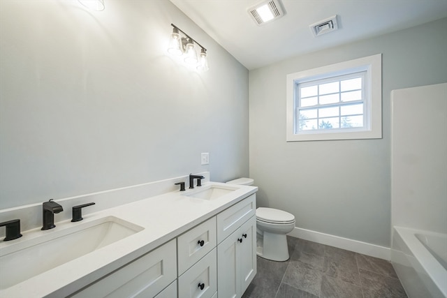 bathroom featuring vanity, a bathtub, and toilet