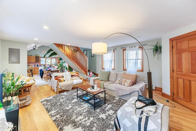 living room featuring hardwood / wood-style floors, plenty of natural light, and a baseboard radiator