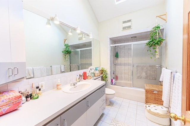 full bathroom featuring tile patterned flooring, toilet, shower / bath combination with glass door, decorative backsplash, and vanity