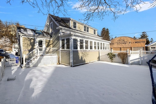 view of snow covered rear of property