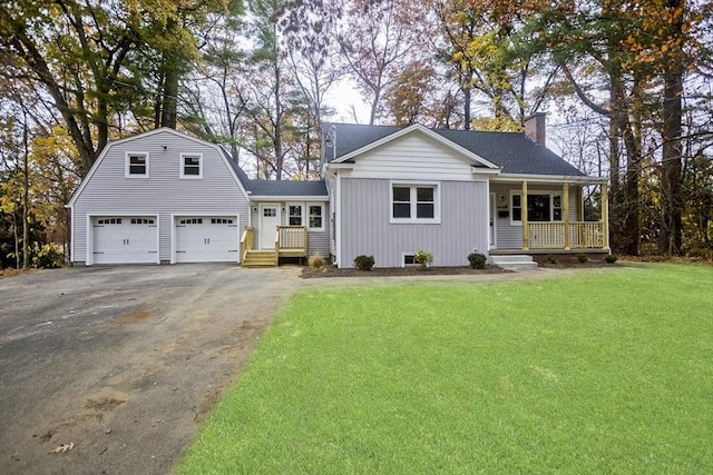 view of front facade featuring driveway, a gambrel roof, a chimney, a porch, and a front yard