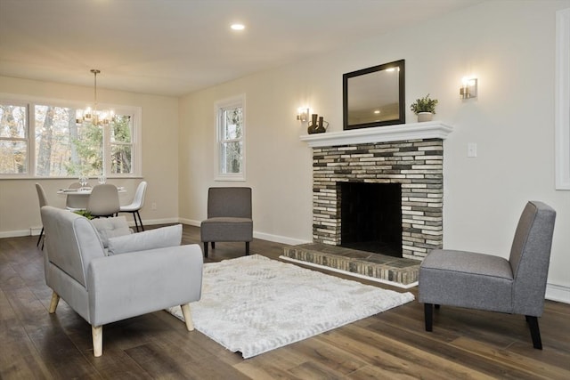 living room featuring dark wood-style floors, a fireplace, and baseboards