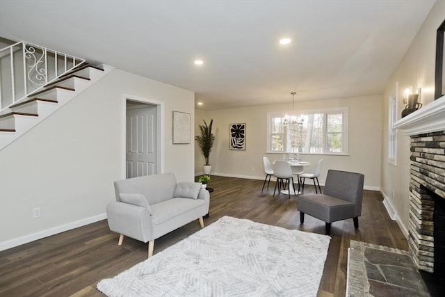 living area featuring baseboards, stairway, dark wood-type flooring, a fireplace, and recessed lighting