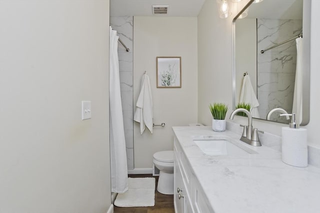 full bathroom featuring visible vents, vanity, and toilet