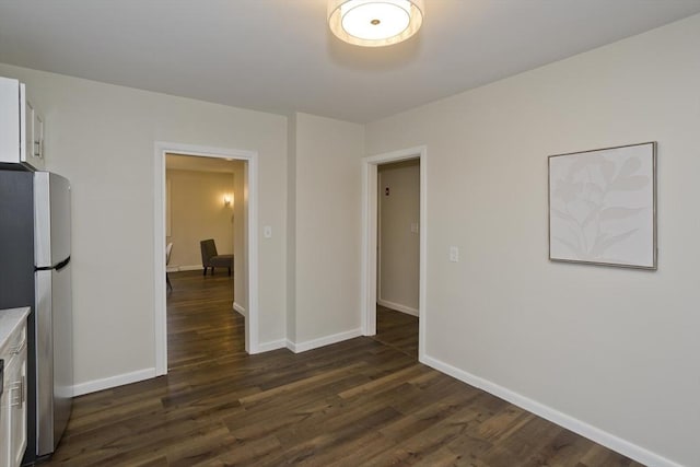 interior space featuring dark wood-style floors and baseboards