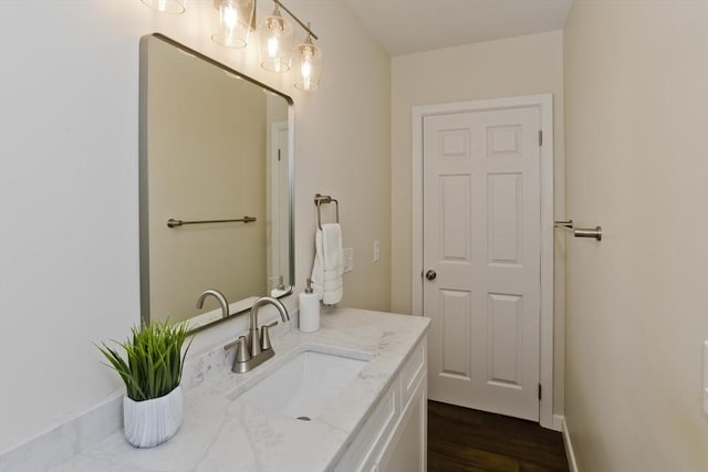 bathroom with wood finished floors and vanity