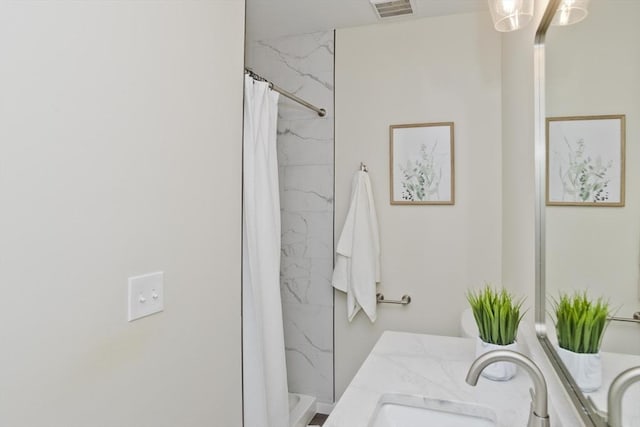 full bathroom with visible vents, a sink, a shower with shower curtain, and double vanity