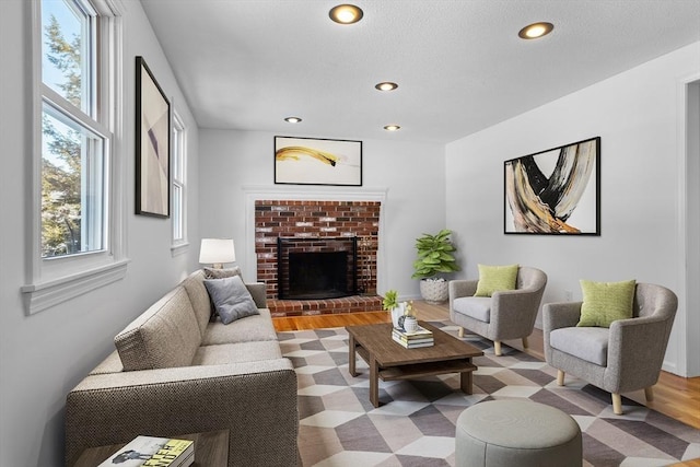 living area with a brick fireplace and recessed lighting