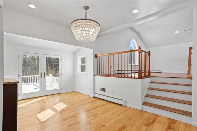 interior space with stairway, lofted ceiling, french doors, wood-type flooring, and baseboard heating