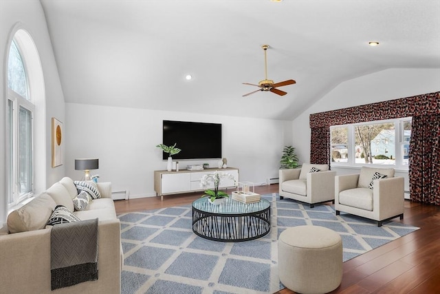 living area with a baseboard radiator, baseboard heating, wood finished floors, and vaulted ceiling