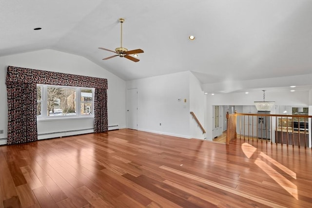 unfurnished living room featuring baseboards, vaulted ceiling, baseboard heating, ceiling fan with notable chandelier, and wood finished floors