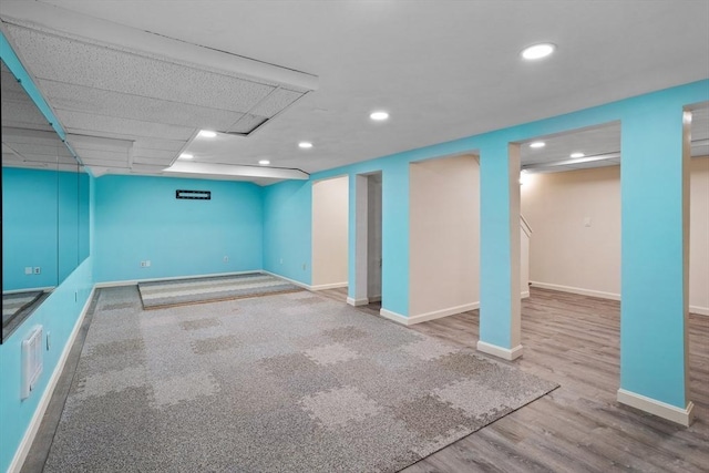 finished basement featuring recessed lighting, baseboards, and wood finished floors