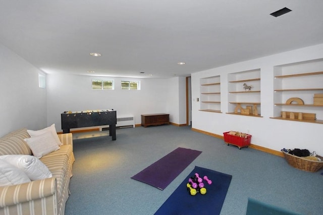 game room with built in features, baseboards, radiator heating unit, recessed lighting, and carpet
