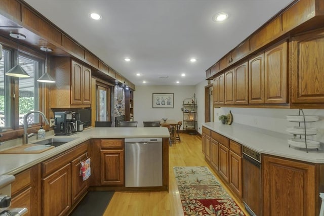 198 Mountain View Dr, Holyoke, MA 01040 - kitchen with dishwasher, a sink, a peninsula, light wood-style flooring, and light countertops