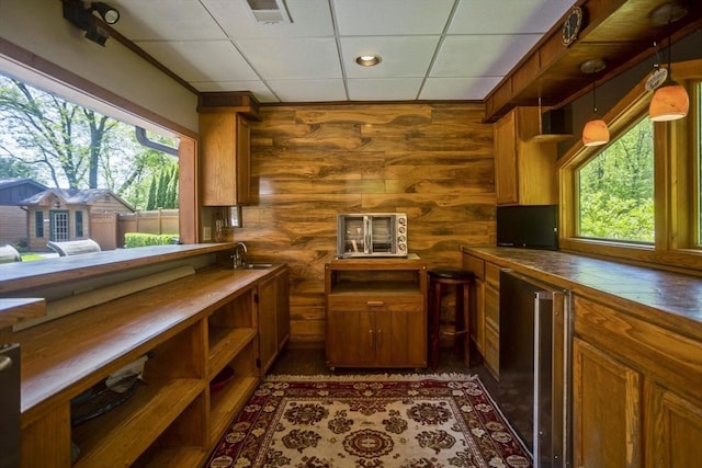 198 Mountain View Dr, Holyoke, MA 01040 - kitchen featuring healthy amount of natural light, a sink, brown cabinets, and log walls