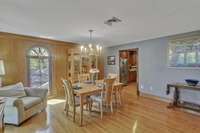 198 Mountain View Dr, Holyoke, MA 01040 - dining area featuring a chandelier, light wood-style floors, and baseboards