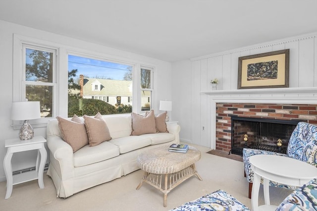 living area with carpet, a fireplace, and a baseboard radiator