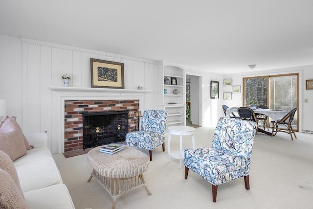 living area featuring a fireplace and carpet flooring