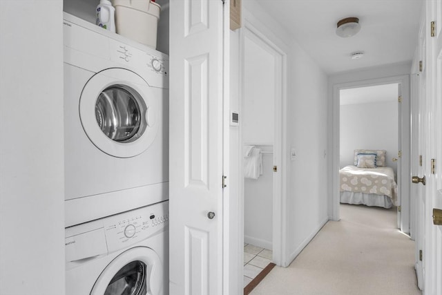 laundry area featuring stacked washer / dryer and laundry area