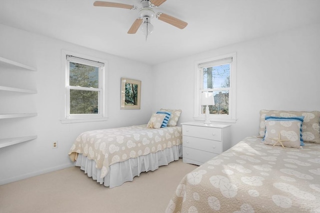 bedroom featuring ceiling fan, baseboards, and light colored carpet