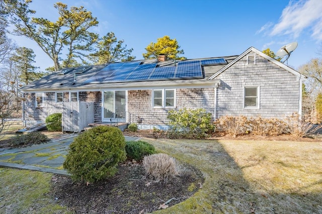 view of front of home with roof mounted solar panels