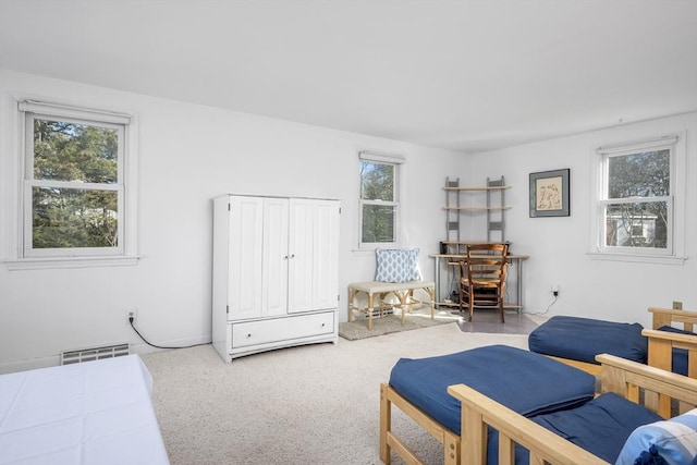 bedroom with multiple windows, visible vents, and carpet flooring