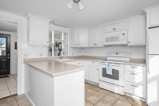 kitchen featuring white appliances, light tile patterned floors, white cabinets, and a sink