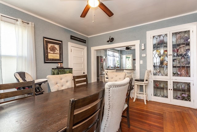 dining space featuring ceiling fan, hardwood / wood-style flooring, and crown molding