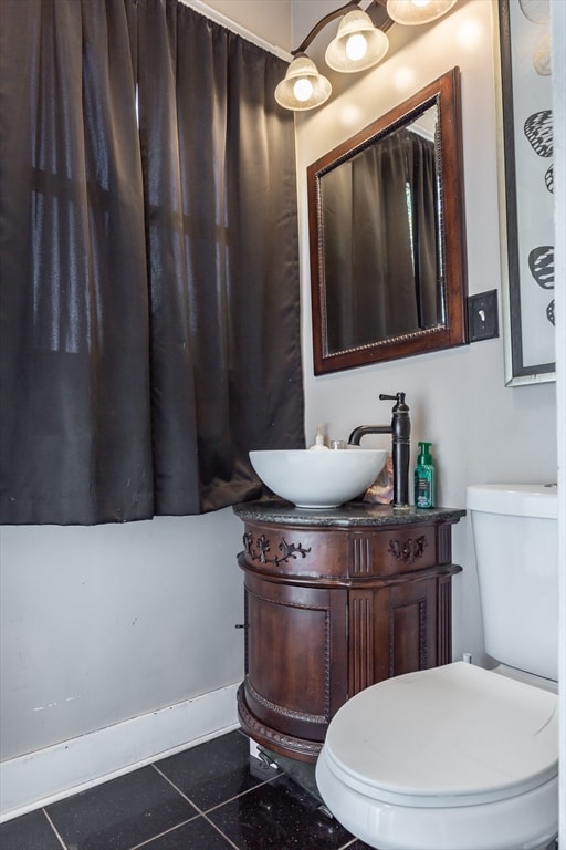 bathroom with vanity, toilet, and tile patterned floors