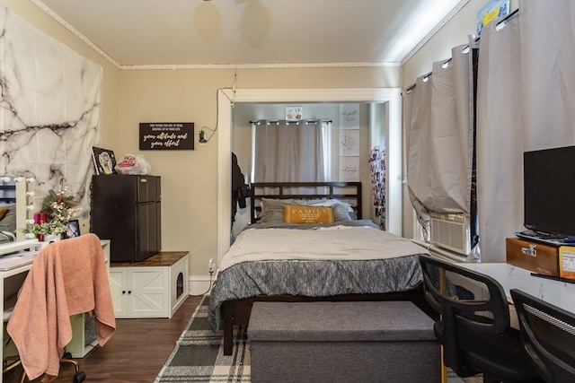 bedroom featuring black fridge, dark hardwood / wood-style floors, and ornamental molding