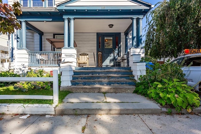 doorway to property featuring covered porch